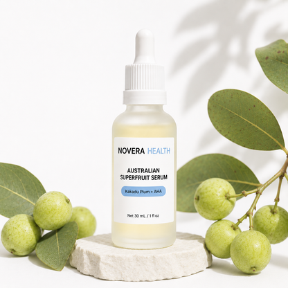 Novera Health Australian Superfruit Serum bottle styled with Kakadu Plum fruit and eucalyptus leaves on a stone pedestal